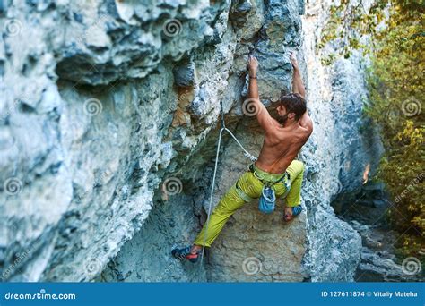 Rock Climbing. Man Rock Climber Climbing the Challenging Route on the ...