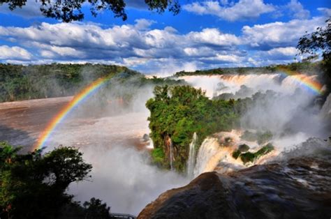 Sunbeams create a lot of rainbows in the mist above the falls iguazu.