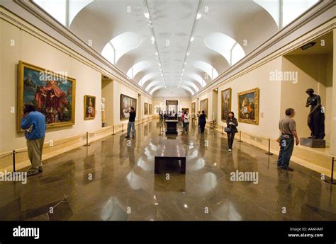 People inside a gallery at The Prado Museum in Madrid Spain looking ...