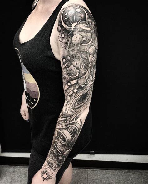 a woman with a black and white tattoo on her arm