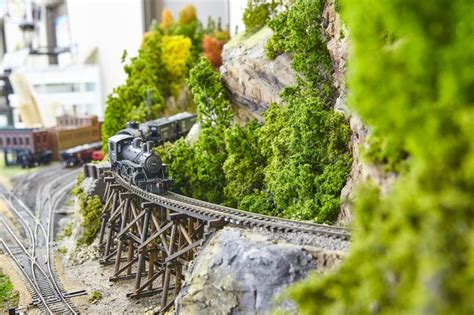 Premium Photo | Detailed miniature train set on trestle bridge with ...