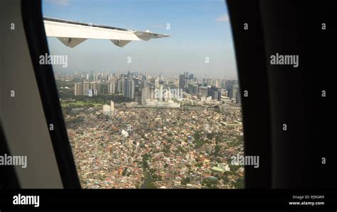 View through an airplane window on the city. Airplane window view ...