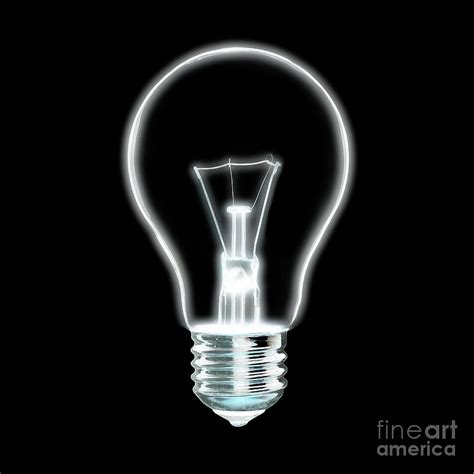 Outline of glowing white Light bulb, on black background. Photograph by ...