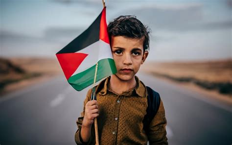 Premium Photo | Palestinian kid girl holding Free Palestine flag in a ...