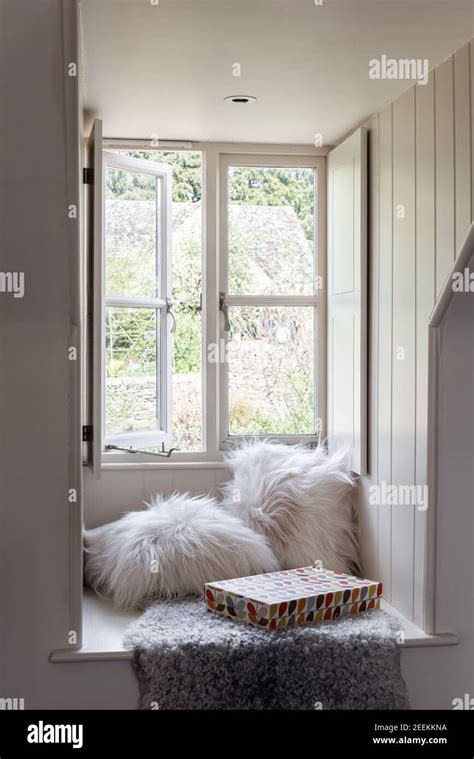 Dormer window seat with sheepskin in loft conversion Stock Photo - Alamy