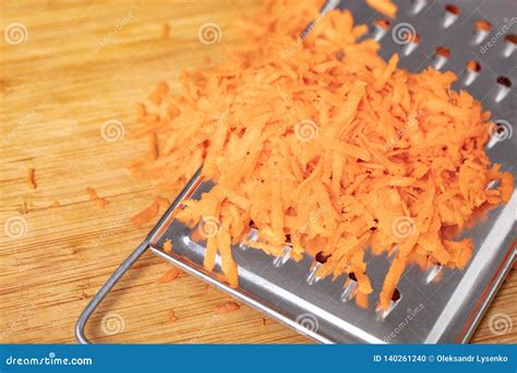 Shredded Carrots on a Grater Closeup Stock Photo - Image of organic ...