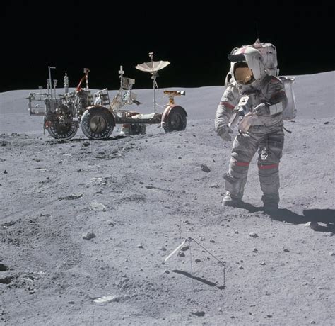 Apollo 16 mission commander John Young does some raking near the lunar ...