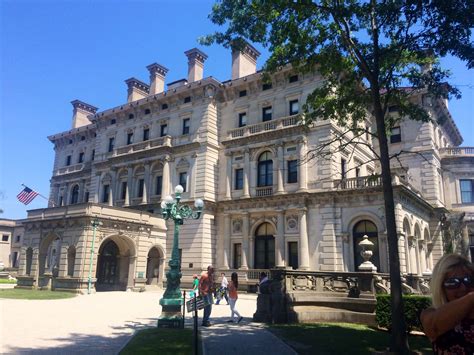 people are walking in front of an old building