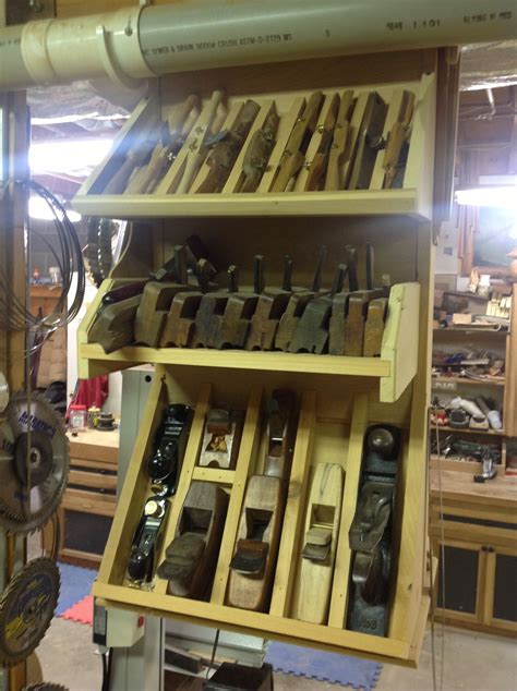 many tools are stored on shelves in a workshop