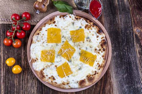 Four Types of Cheese Italian Pizza on a Wooden Floor Stock Image ...