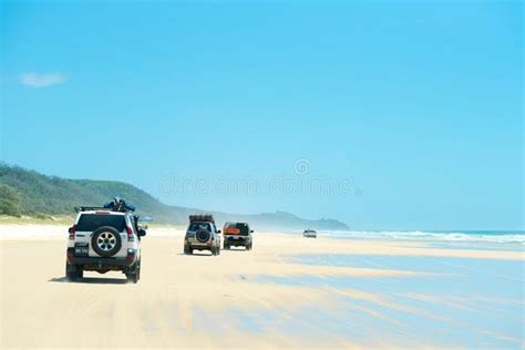 4wd vehicles at Rainbow Beach with coloured sand dunes, QLD, Australia ...