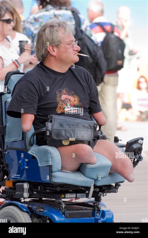 Disabled quadriplegic wheelchair supporter smoking in Olympic Games ...