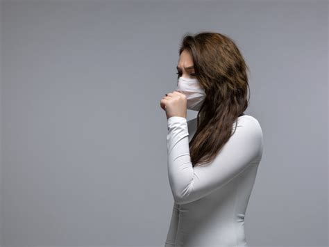 Free Photo | Coughing girl covering her mouth in white protective mask