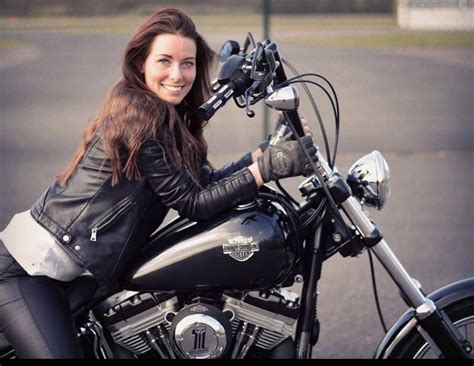 Woman Sitting on Motorcycle in Parking Lot