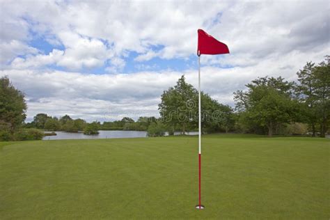 Golf Green with Red Golf Flag Stock Photo - Image of luxury, trees ...