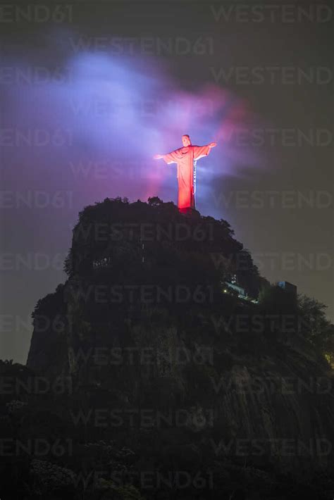 Christ the Redeemer statue with red lights during early night ...