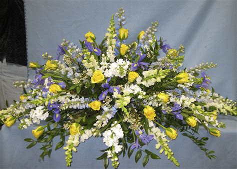 Blue and Yellow Casket Spray in Northport, NY | Fashions In Flowers