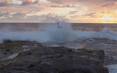 Photographer gets taken out by rogue wave while filming oceanside tutorial