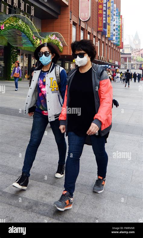 Residents of Beijing wear breathing masks do to bad pollution Stock ...