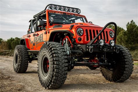 Sapphire Orange Lifted Jeep Wrangler Wears Dark Smoke Headlights ...