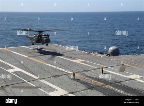 Helicopter landing on aircraft carrier Stock Photo - Alamy