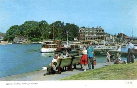 an old postcard shows people sitting on benches near the water with ...