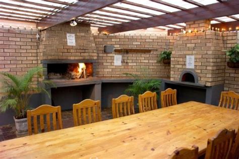 a wooden table sitting in front of a brick oven