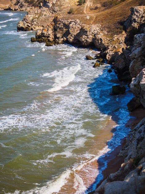 Premium Photo | Beach in a wild fjord bay at sunset