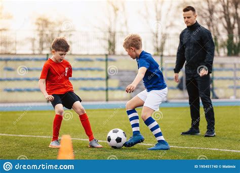 Young Boys on Soccer Practice Training with Coach. Junior Footballers ...