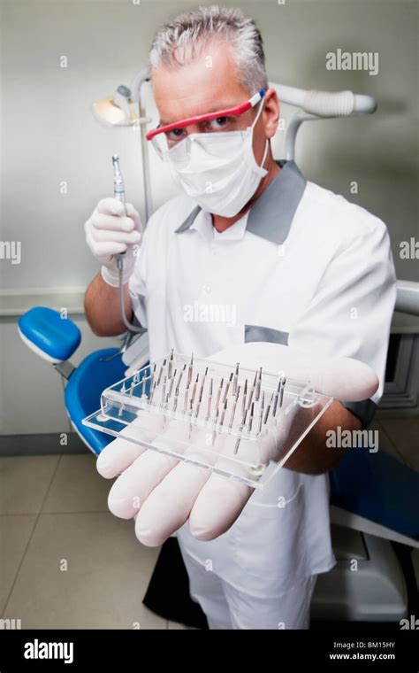 Dentist holding dental drill bits Stock Photo - Alamy