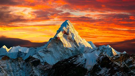 Download 4K Mountain Under Orangish Sky Wallpaper | Wallpapers.com