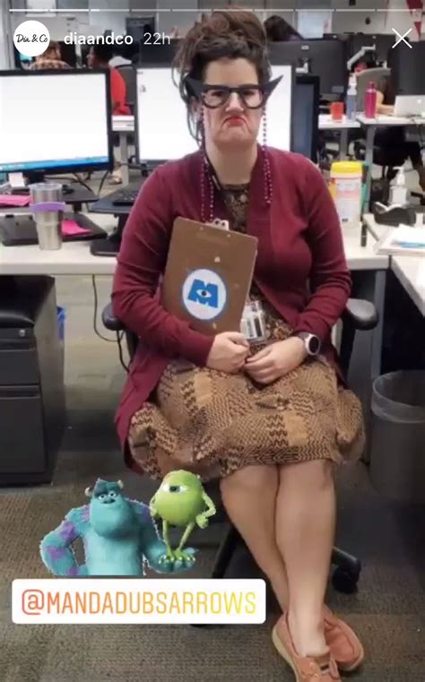 a woman sitting in an office holding a box