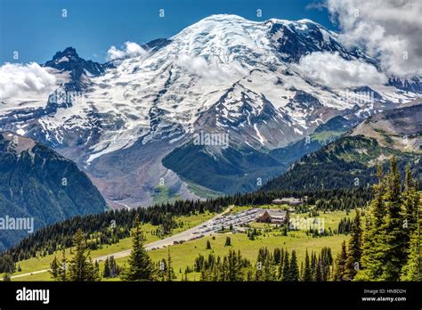 View of Sunrise lodge while hiking with the impressive Mount Rainier in ...