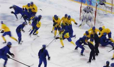 Players from the Swedish women's national ice hockey team take part in ...