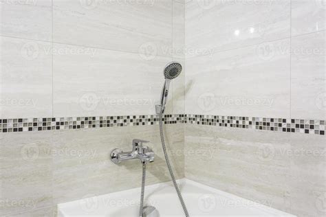 detail of a corner shower cabin with wall mount shower attachment ...