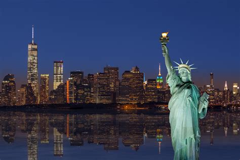 Statue of Liberty and New York City Skyline at Sunset with Manhattan ...