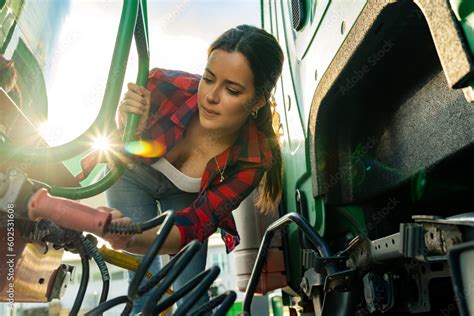 female junior driver checks the truck's equipment, practices safe ...