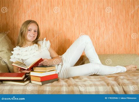 Girl Reading Book On Sofa Royalty Free Stock Image - Image: 17833946