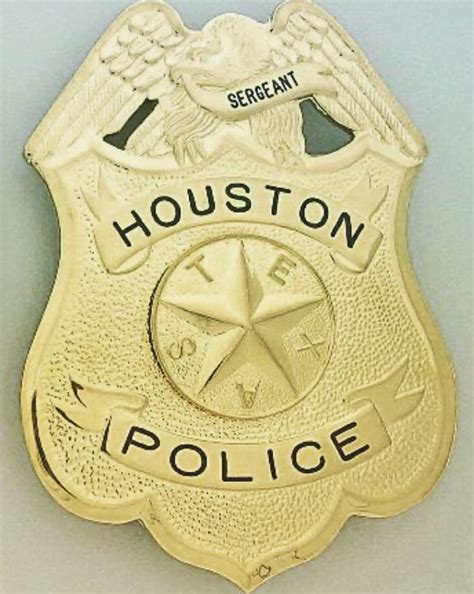 two houston police badges, one gold and the other black