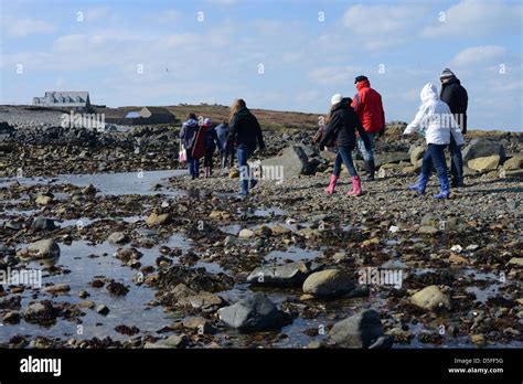 visitors cross the causeway between Guernsey and Lihou Island Stock ...