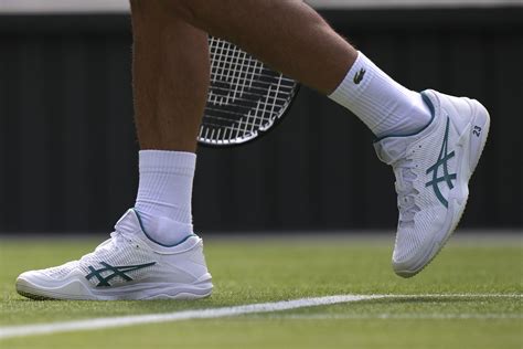 Novak Djokovic plays at Wimbledon with the number '23' printed on his ...