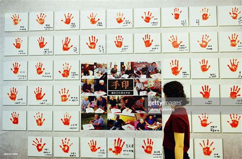 A woman walks by palm prints of comfort women during a show... News ...