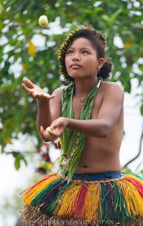 Yapese girl in traditional clothing juggling fruit at Yap Day Festival ...