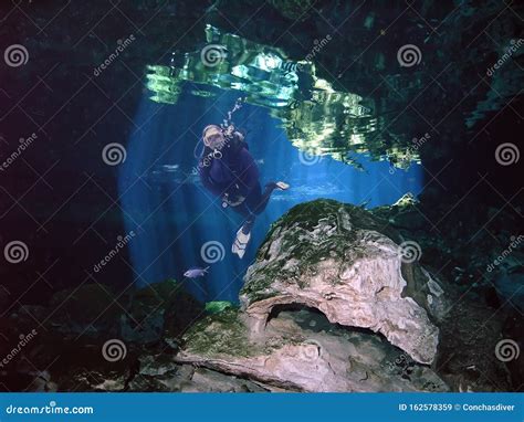 A SCUBA Diver Fins through a Yucatan Cenote Stock Image - Image of ...