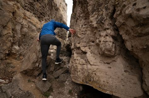 Free Photo | Young man climbing rocks