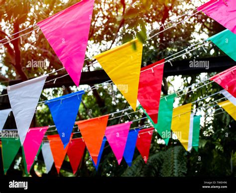 Colorful festival flags hanging in the garden. Beautiful colour of ...