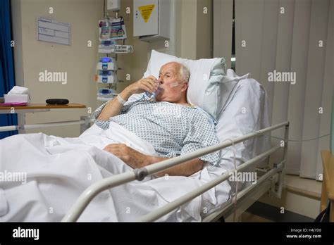 Elderly man (83) recovering in his hospital bed in the cardiac ward ...