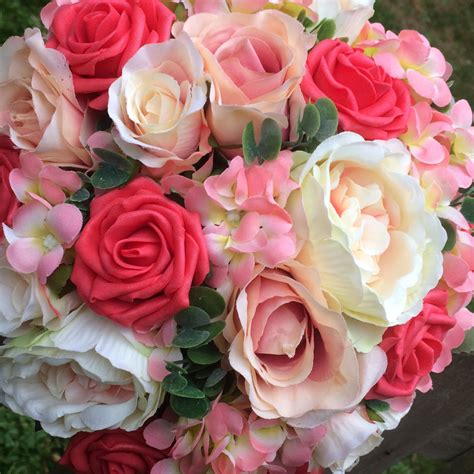 A brides bouquet featuring apricot, coral and peach roses & hydrangea ...