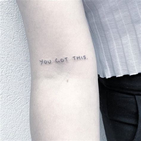 "You got this" lettering tattoo on the bicep.