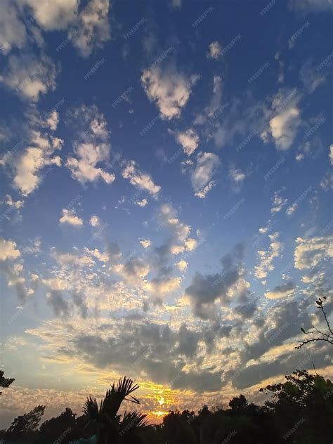 Premium Photo | A blue sky with clouds and a sunset in the background